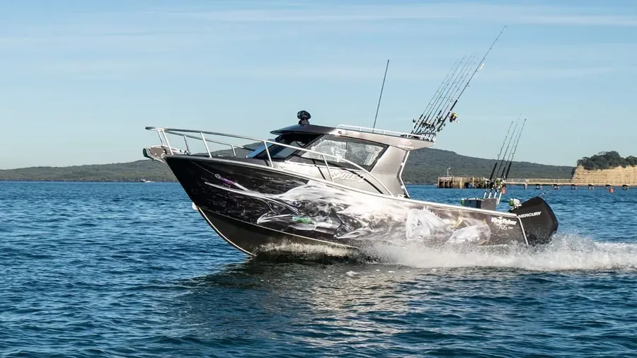 Close detail of shark and tuna artwork on the Kingfisher 705 hull